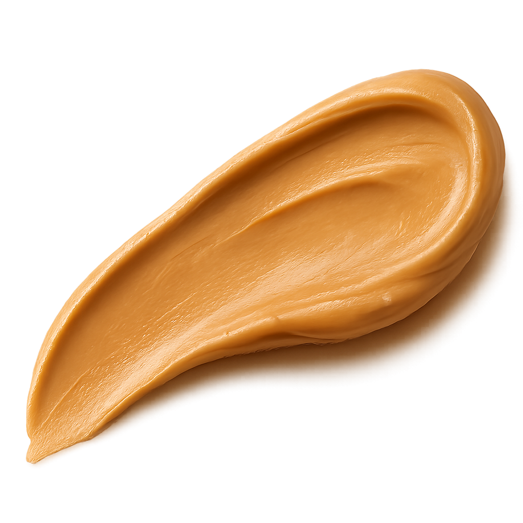 A smooth, appetizing peanut butter swash spread in an elegant curved stroke, rich golden-beige tones, creamy and glossy texture with natural highlights, appearing thick and luscious. The edges of the spread are soft and organic, as if lightly smoothed with a knife. Warm soft lighting to enhance depth and richness. Include a gentle, realistic shadow beneath the swash so it appears resting on the label surface. No background, no plate or surface — transparent PNG, photorealistic detail, premium artisanal food styling, refined and minimal, cozy warm visual mood.make the swash shape slightly dynamic and flowing, like a natural brush stroke, visually guiding the eye across the label.
