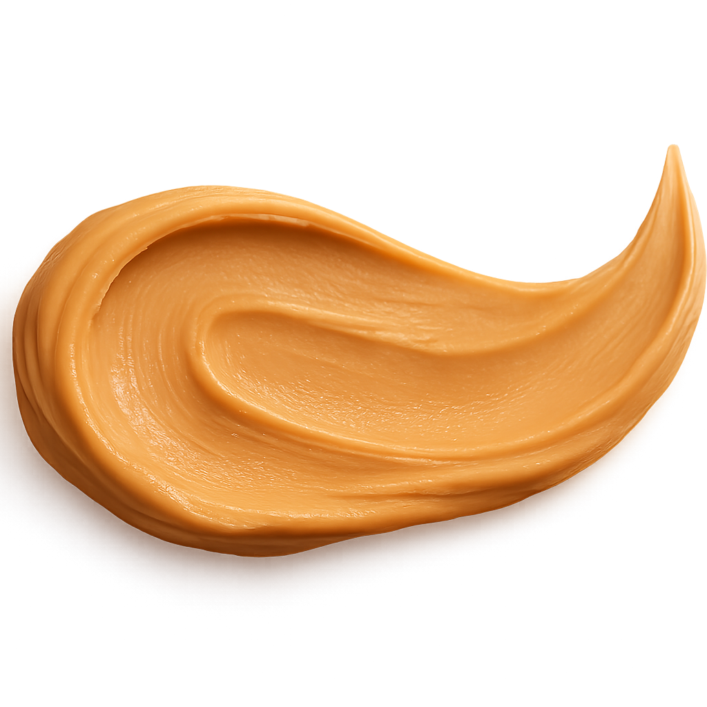 A realistic, appetizing long flowing swash of creamy smooth peanut butter spread in a graceful, painterly stroke. Rich golden-beige tones, velvety texture, natural glossy highlights, and soft subtle ridges from spreading. The shape should be elongated, elegant, and slightly curved, as if gently swept with a single smooth motion. Soft warm studio lighting for a premium, cozy, artisanal look. Include a soft, natural shadow beneath the peanut butter so it appears resting on a label surface. No background, no knife, no plate — transparent PNG. Centered composition, photorealistic detail, high-end food photography style.