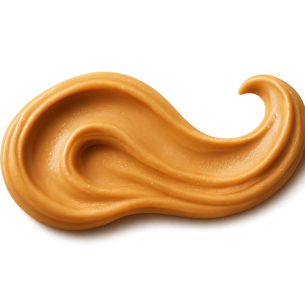A realistic swirl-style stroke of creamy smooth peanut butter flowing gently across the top area of the label, forming a soft looping curve. The peanut butter should appear thick, velvety, and richly creamy with natural glossy highlights and subtle texture ridges. The swirl shape should feel elegant and organic, like a graceful stroke made with a spatula, not too heavy or clumped. Use soft warm studio lighting to enhance depth and richness. Include a soft, natural shadow beneath the peanut butter to make it appear physically resting on the label surface. No background, no plate, no table — transparent PNG. Centered horizontal composition, photorealistic, high-end artisanal food photography quality.