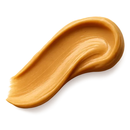 A smooth, appetizing peanut butter swash spread in an elegant curved stroke, rich golden-beige tones, creamy and glossy texture with natural highlights, appearing thick and luscious. The edges of the spread are soft and organic, as if lightly smoothed with a knife. Warm soft lighting to enhance depth and richness. Include a gentle, realistic shadow beneath the swash so it appears resting on the label surface. No background, no plate or surface — transparent PNG, photorealistic detail, premium artisanal food styling, refined and minimal, cozy warm visual mood.make the swash shape slightly dynamic and flowing, like a natural brush stroke facing to the left , visually guiding the eye across the label.