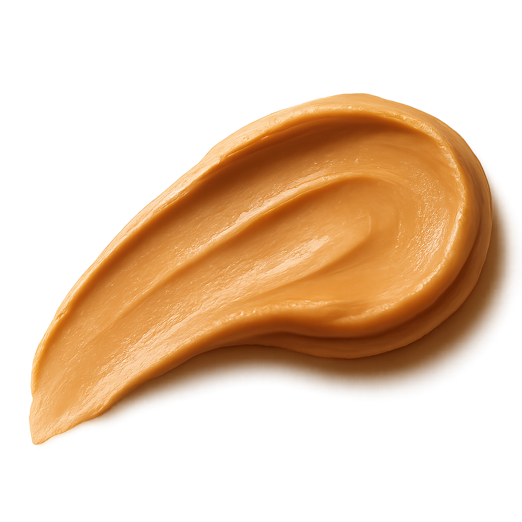 A smooth, appetizing peanut butter swash spread in an elegant curved stroke, rich golden-beige tones, creamy and glossy texture with natural highlights, appearing thick and luscious. The edges of the spread are soft and organic, as if lightly smoothed with a knife. Warm soft lighting to enhance depth and richness. Include a gentle, realistic shadow beneath the swash so it appears resting on the label surface. No background, no plate or surface — transparent PNG, photorealistic detail, premium artisanal food styling, refined and minimal, cozy warm visual mood.make the swash shape slightly dynamic and flowing, like a natural brush stroke, visually guiding the eye across the label.make it facing to the left.